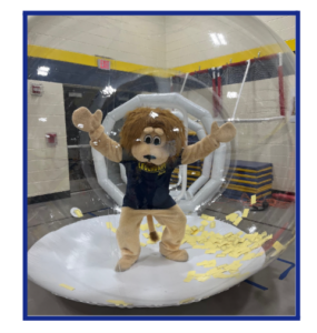 Leo the mascot in a big clear bubble inflatable that blows tickets around inside to catch.